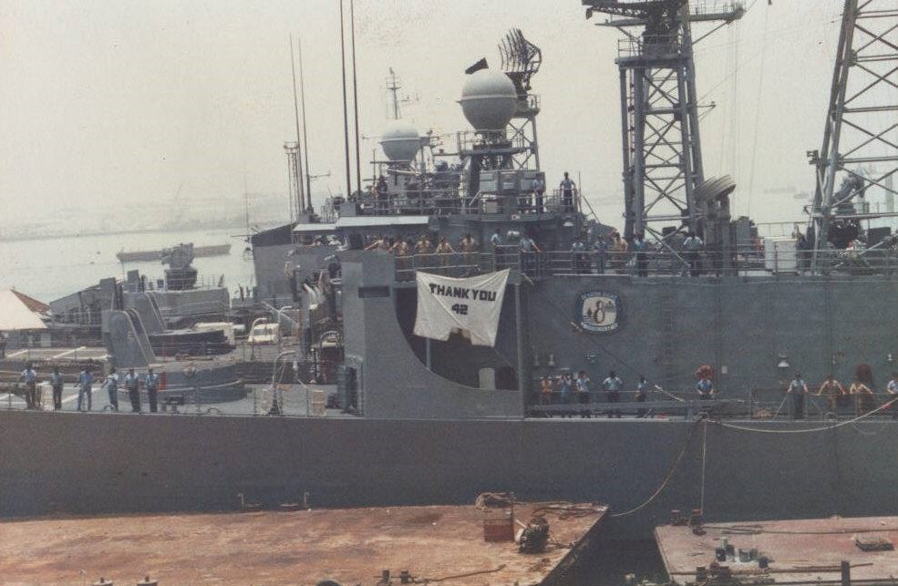 July 1987: USS Stark crew saying 'Thank You' to the USS Acadia AD-42 for their support and dedication in rebuilding the ship enough to be 
                            sailed home on her own power.